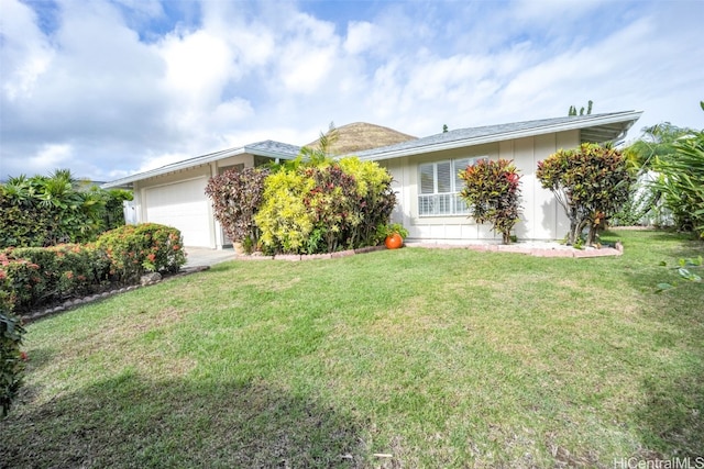 ranch-style home featuring a garage and a front lawn