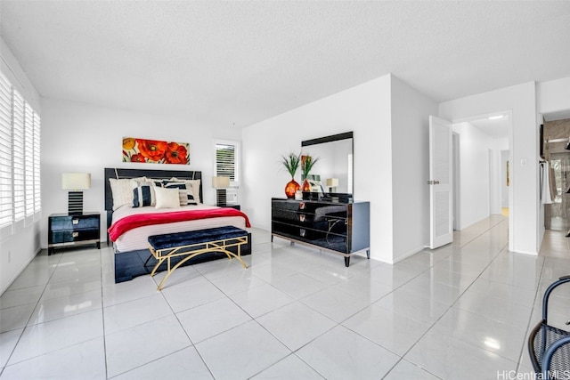 tiled bedroom with multiple windows and a textured ceiling