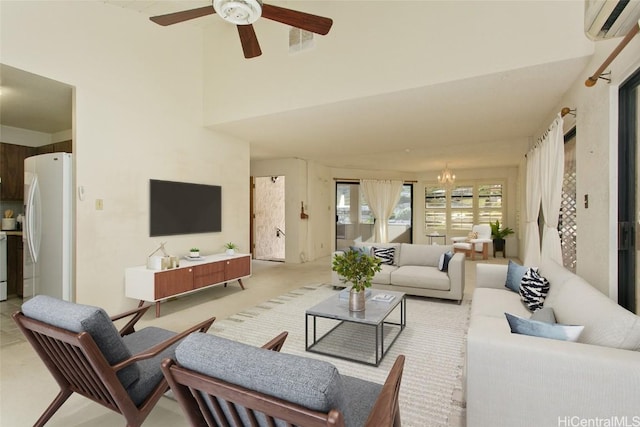 living room featuring ceiling fan with notable chandelier and a wall unit AC