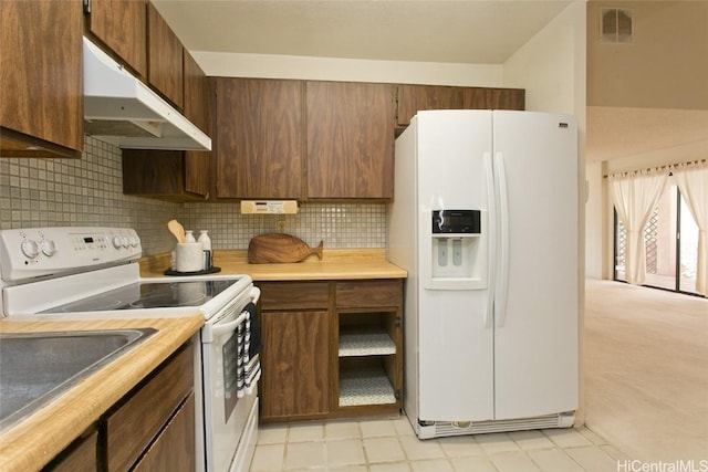 kitchen with tasteful backsplash and white appliances