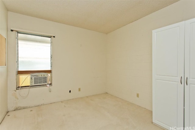 empty room with cooling unit and a textured ceiling