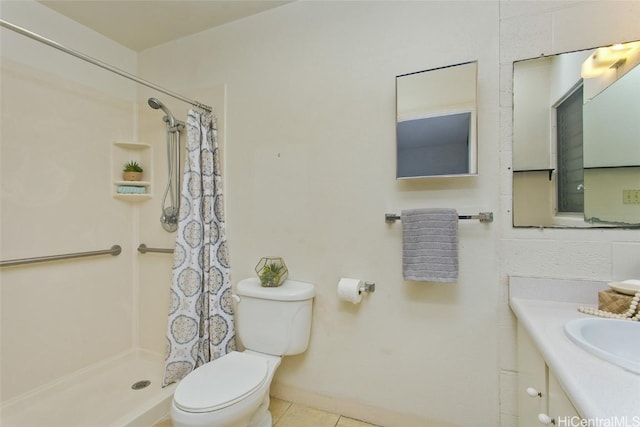 bathroom with vanity, tile patterned floors, toilet, and walk in shower