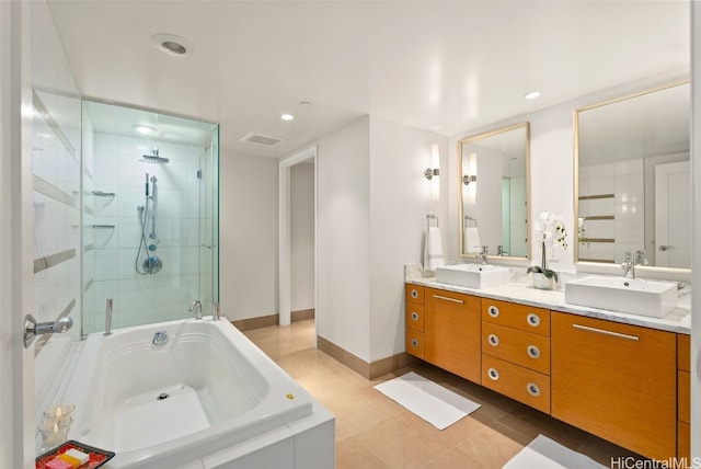 bathroom featuring vanity, plus walk in shower, and tile patterned flooring