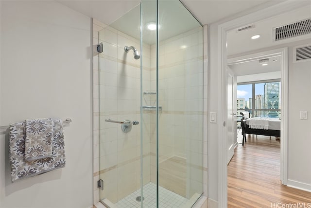 bathroom featuring an enclosed shower and hardwood / wood-style floors