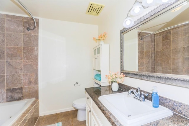 full bathroom with tiled shower / bath, tile patterned floors, toilet, and vanity