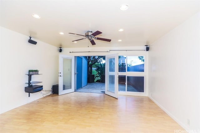 unfurnished room featuring french doors, ceiling fan, and light hardwood / wood-style floors