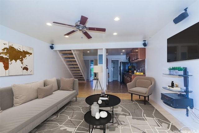 living room featuring wood-type flooring and ceiling fan