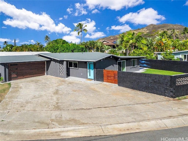 view of front of property with a garage and a mountain view