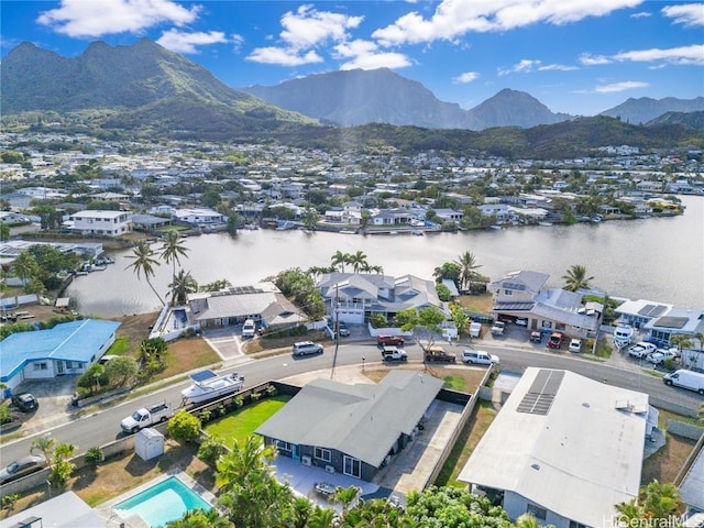 birds eye view of property with a water and mountain view