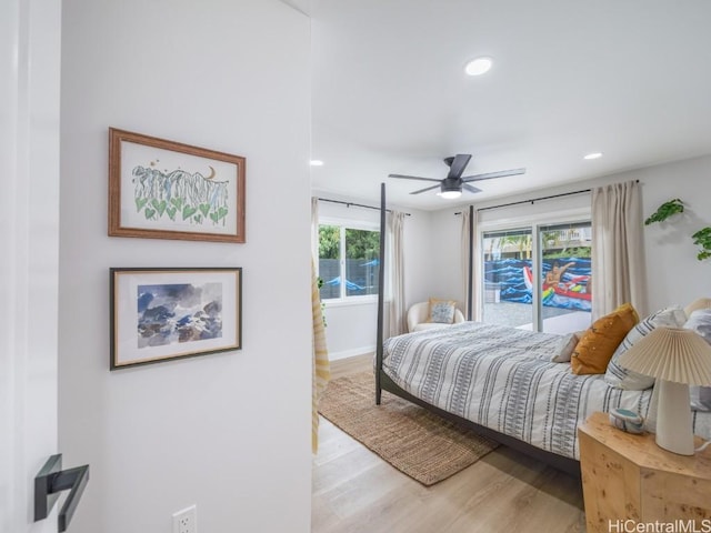 bedroom featuring multiple windows, access to outside, light hardwood / wood-style floors, and ceiling fan