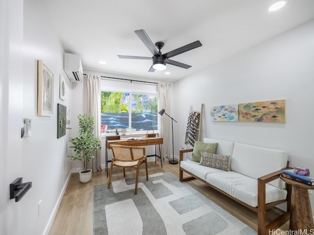 living area featuring ceiling fan, a wall mounted AC, and light wood-type flooring