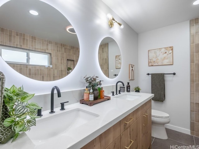 bathroom with tile patterned flooring, vanity, and toilet