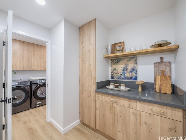 laundry room with light hardwood / wood-style flooring and independent washer and dryer