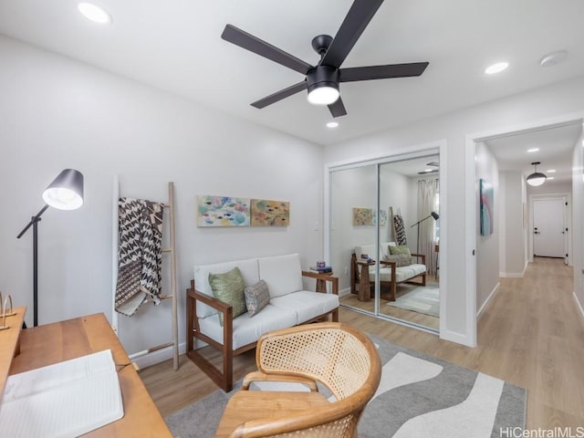 sitting room featuring ceiling fan and light wood-type flooring