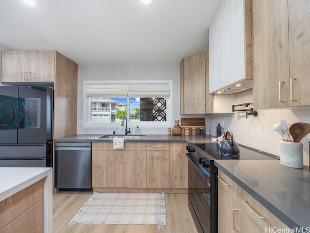 kitchen featuring light brown cabinetry, sink, black electric range, and stainless steel dishwasher