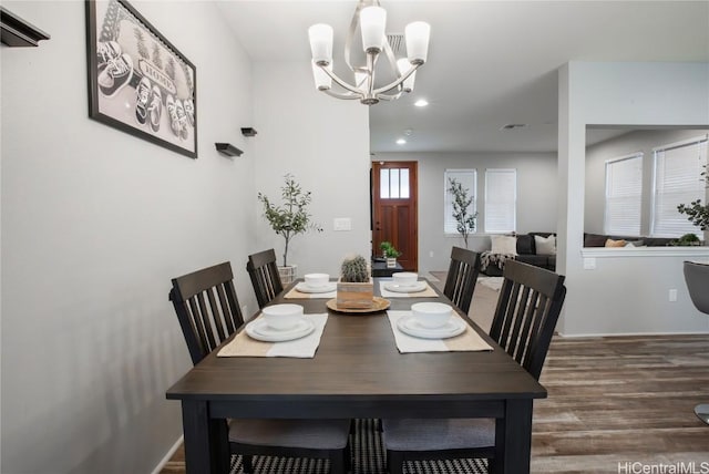 dining area featuring an inviting chandelier and dark hardwood / wood-style floors