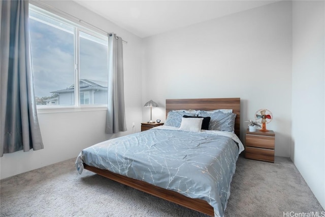 bedroom with multiple windows and carpet flooring