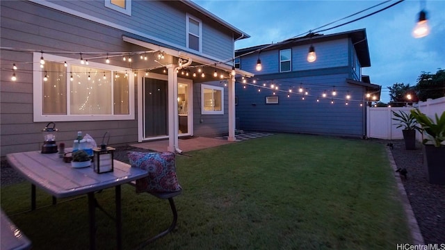 rear view of property featuring a patio area and a lawn