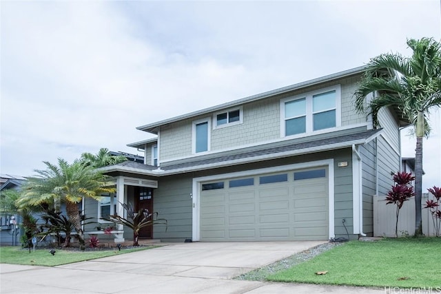 view of front of property with a garage and a front lawn