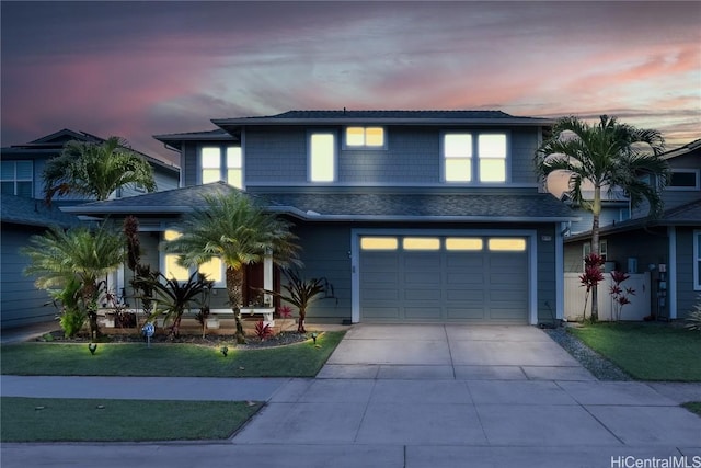 view of front of home featuring a yard and a garage