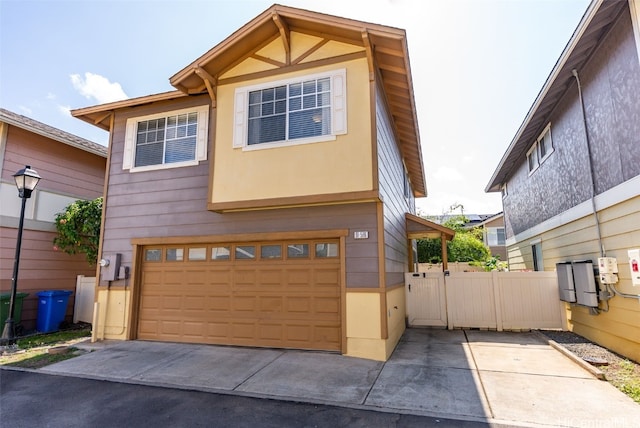 view of front facade featuring a garage, fence, and stucco siding