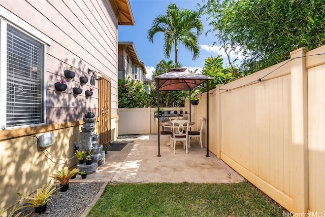 view of patio / terrace with a gazebo and a fenced backyard