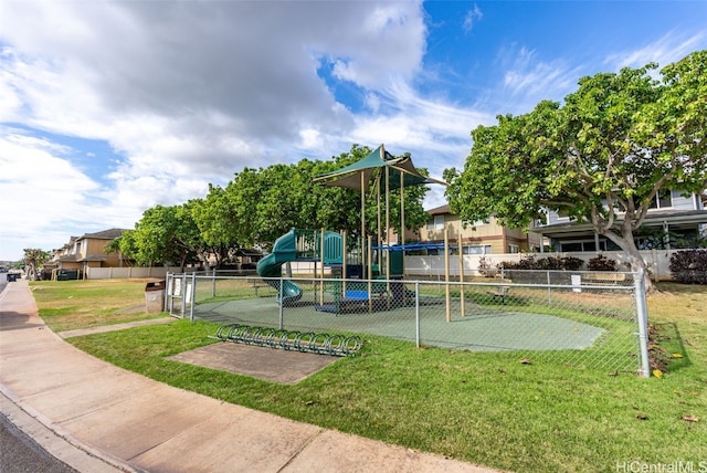 communal playground with a yard and fence