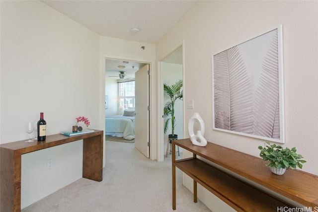 hall with light colored carpet