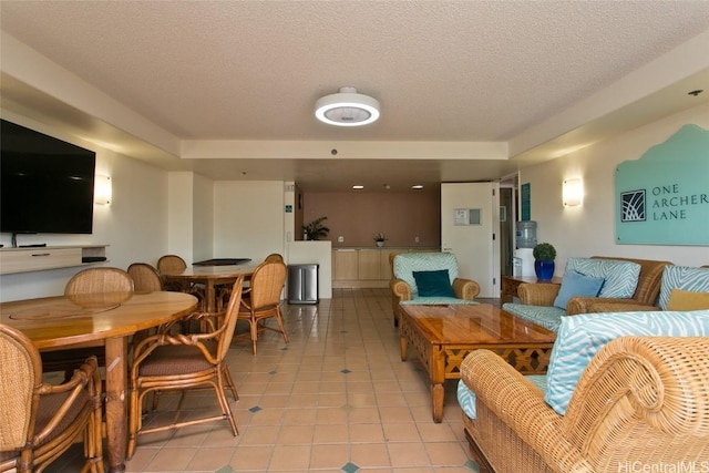 living room with light tile patterned flooring and a textured ceiling