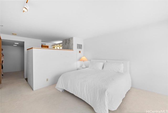 bedroom with light colored carpet