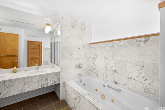 bathroom featuring vanity, tiled tub, and tile patterned floors