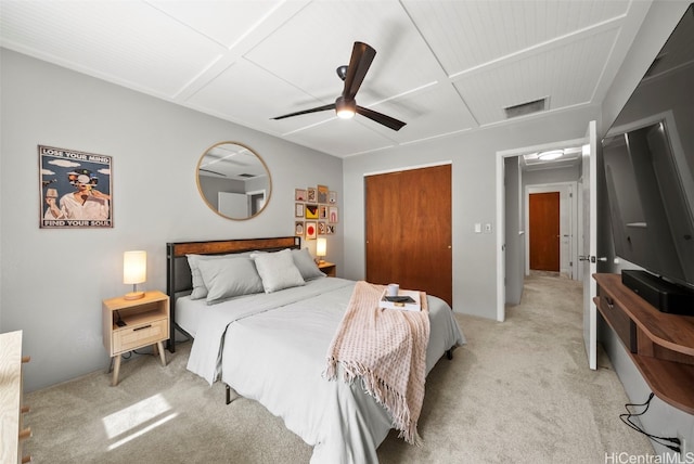 bedroom featuring ceiling fan, a closet, and light carpet