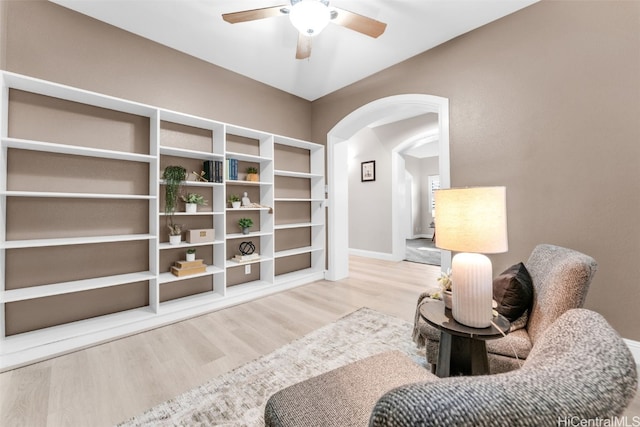 living area featuring hardwood / wood-style floors and ceiling fan