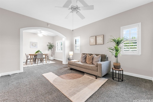 living room with ceiling fan and carpet floors