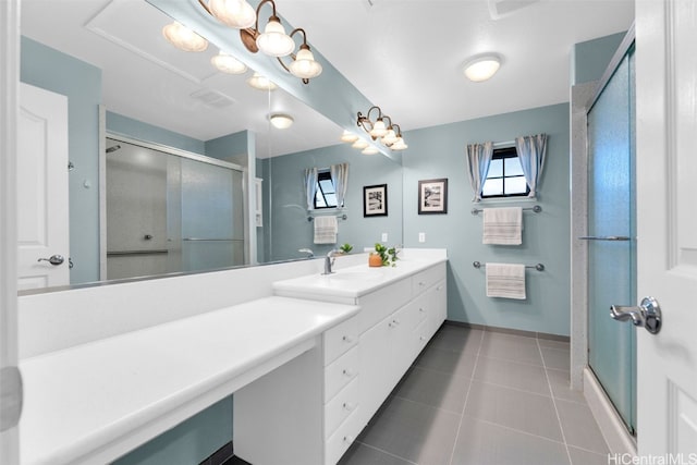 bathroom featuring tile patterned floors, vanity, and a shower with door