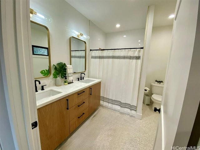 bathroom featuring vanity, toilet, and a shower with shower curtain