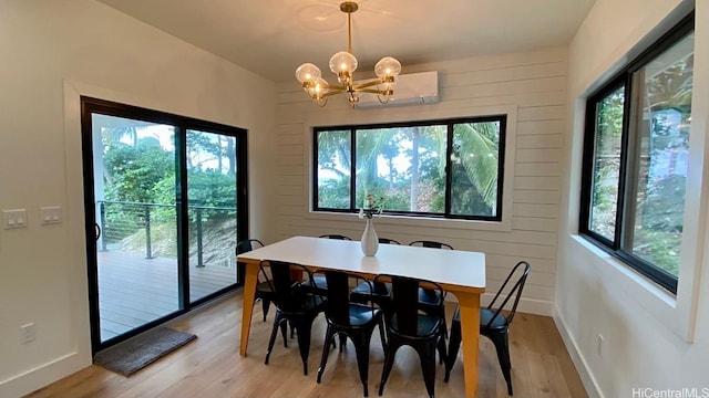 dining area with a notable chandelier and light wood-type flooring