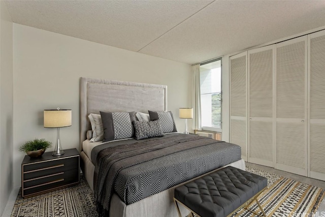 bedroom with a textured ceiling and a closet