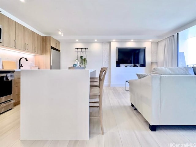 kitchen with stainless steel appliances, sink, and a kitchen island