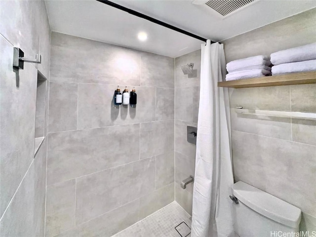 bathroom with toilet and a shower with shower curtain