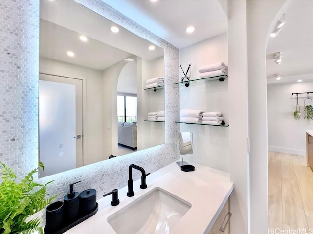 bathroom featuring hardwood / wood-style flooring and vanity