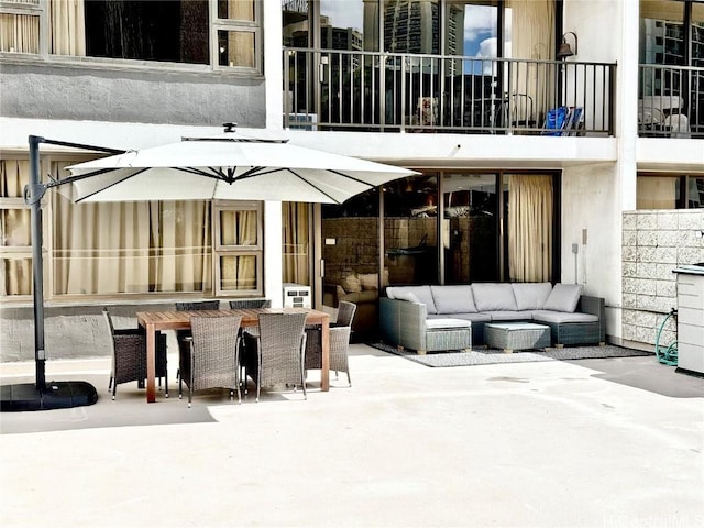 view of patio / terrace featuring outdoor dining area, a balcony, and an outdoor living space