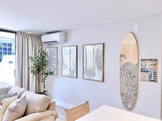 interior space featuring an AC wall unit and baseboards