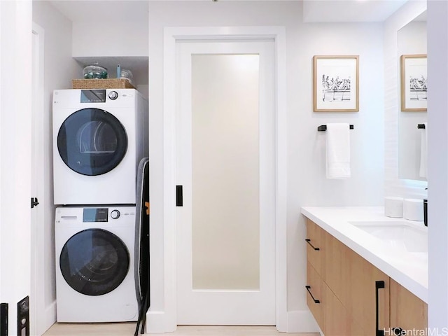 clothes washing area featuring laundry area and stacked washing maching and dryer