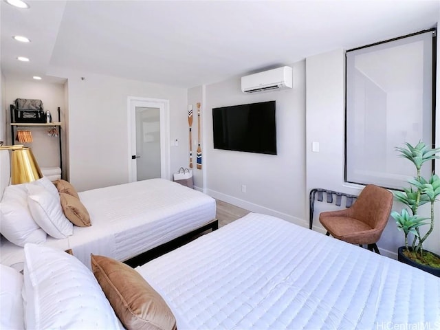 bedroom featuring recessed lighting, wood finished floors, baseboards, and a wall mounted AC