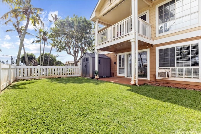 view of yard with a storage shed, a patio area, and a balcony