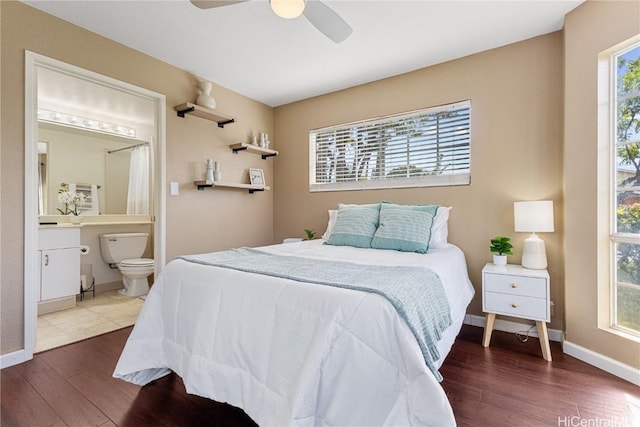 bedroom with hardwood / wood-style flooring, ceiling fan, and ensuite bathroom