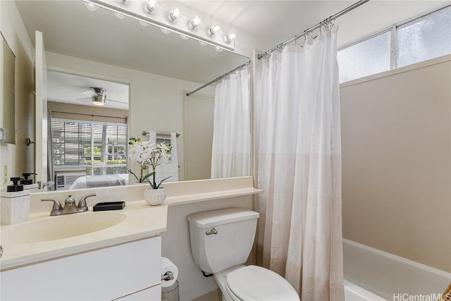 full bathroom featuring vanity, ceiling fan, toilet, and shower / bath combo with shower curtain