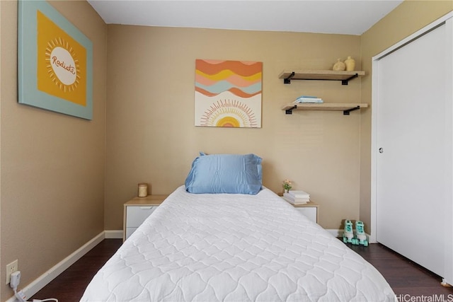 bedroom with dark hardwood / wood-style floors