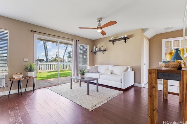 living room with dark wood-type flooring and ceiling fan